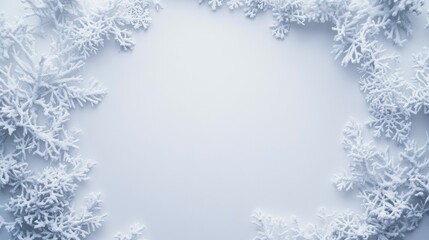 Frosty winter background with delicate snowflakes surrounding a blank center perfect for holiday designs or seasonal greetings and festive decorations