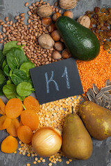 An example of a range of products containing vitamin K1. The concept of proper balanced nutrition. Products with the inscription vitamin K1 on a dark background, top view.