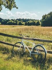 Bicycle resting against wooden fence in a sunny meadow surrounded by trees in a rural area during daylight. Generative AI