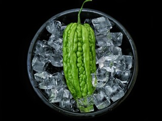 bitter melon fruit isolated on black bowl black background