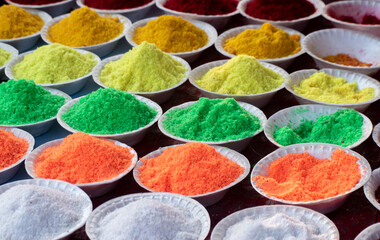 A vibrant assortment of food colors in small bottles for culinary use.