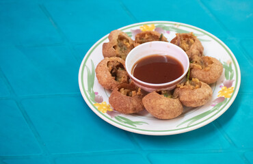 A plate of Fuchka, a popular Bangladeshi traditional street food.
