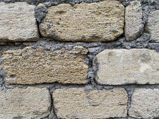 Stone wall showing texture and variations in color in a constructed setting