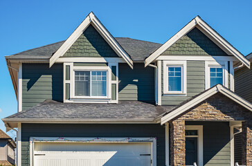 Facade of a house with nice windows. Real Estate Exterior Front House in a residential neighborhood.