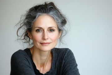 A portrait of a beautiful, mature European woman. A gorgeous woman in her 40s-50s, looking at the camera, set against a white background