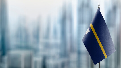 Small flags of the Nauru on an abstract blurry background