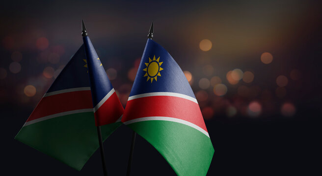 Small flags of the Namibia on an abstract blurry background