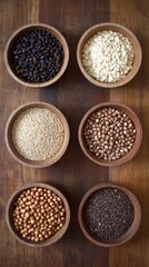 Collection of Six Different Types of Seeds and Grains in Wooden Bowls