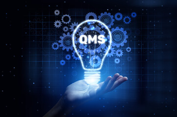 QMS Quality Management System Enhancing Compliance and Process Improvement with Human Hand Holding Lamp Hologram.