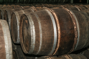 A stack of barrels with the top barrel being the largest. The barrels are made of wood and are stacked on top of each other