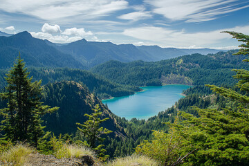 Fototapeta premium Crystal Clear Mountain Lake with Lush Green Forest and Rocky Shore Under Bright Blue Sky