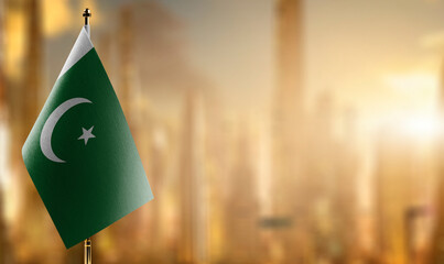 Small flags of the Pakistan on an abstract blurry background