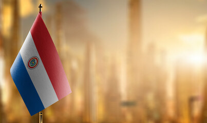 Small flags of the Paraguay on an abstract blurry background
