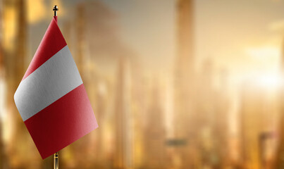 Small flags of the Peru on an abstract blurry background