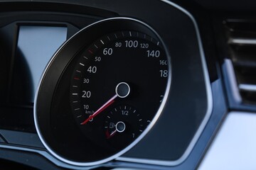 Close-up of car speedometer and fuel gauge