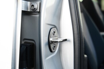 Close-up of a car door lock and handle mechanism
