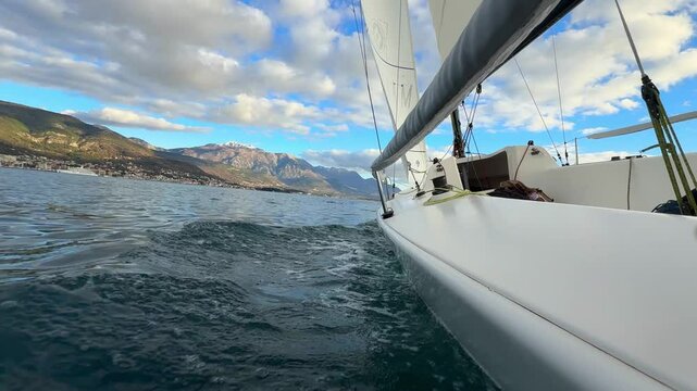 Sports yacht sailing in the Kotor Bay, Montenegro, representing adventure, freedom, and nautical exploration.