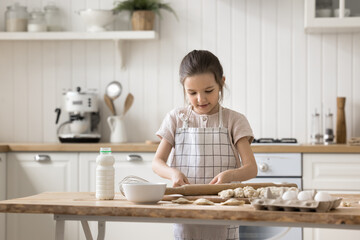 I love cooking from childhood. Smart little girl of early school age wear kitchen apron enjoy...