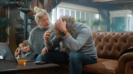 Annoyed elderly man is stressed due to insufficient money on the card for online payment, financial crisis, and upset retired couple at home with a laptop,  bankruptcy, and unpaid bills loan bank debt