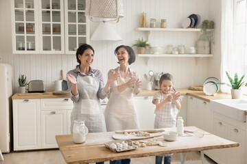 Funny messing when doing chores. Overjoyed excited family of 3 female generations senior granny...