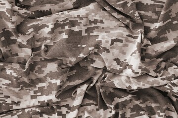 Texture of Dark green pixel camouflage military uniform textile cloth with folds