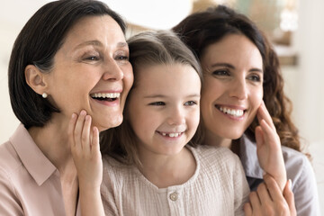 Happy family dynasty. Close up portrait smiling loving three female generations cute little girl...