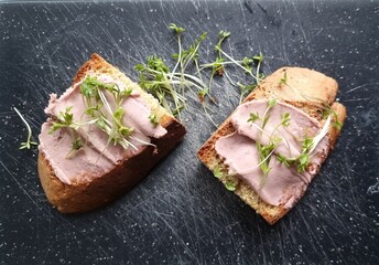Sausage sandwich garnished with garden cress