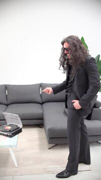 Man Dancing Like Elvis in 60s Style at Home, Finger Snapping by Sofa