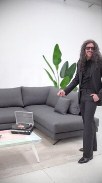 Man Dancing Like Elvis in 60s Style at Home, Finger Snapping by Sofa