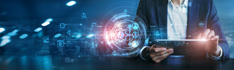 ERP. Businessman using a tablet to analyze Enterprise Resource Planning (ERP) systems, financial data, inventory levels, sales performance, business analytics, operational efficiency, decision-making.