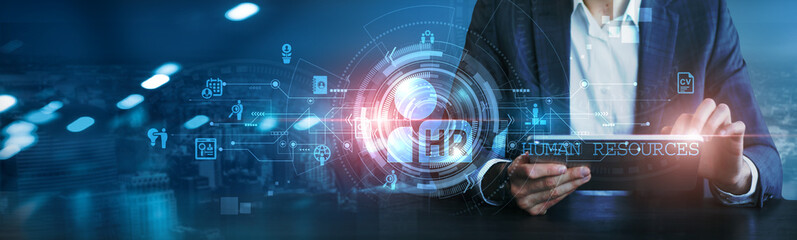 Businessman using a tablet analyzing employee performance, recruitment strategies, training programs, workforce diversity, employee engagement, HR analytics, benefits administration, compliance issues