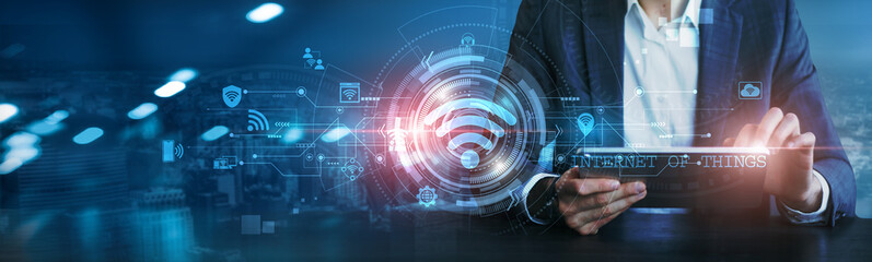 IOT. Businessman using tablet analyzing data from connected devices, leveraging the Internet of Things to optimize operations and decision-making.