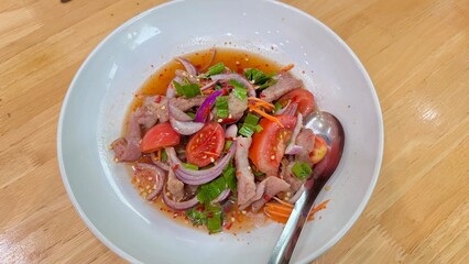 Grilled meat spicy salad. Thai food. Thai salad style on a white dish