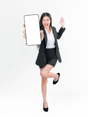 Energetic business woman in a black suit excitedly holding a big smartphone with a blank white screen, perfect for technology, advertising, and business concepts, isolated on a white background