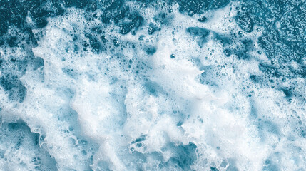Foamy ocean waves crashing with dynamic energy, creating textured white and blue surface
