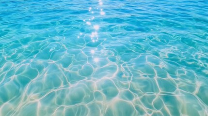 Obraz premium Gentle Ripples in Light Blue Water Reflecting Sunlight Creating a Calm and Serene Ocean Texture