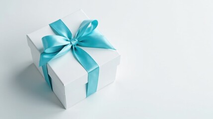 Obraz premium A pristine white gift box adorned with a delicate light blue satin ribbon, a symbol of thoughtful presentation and joyous celebration