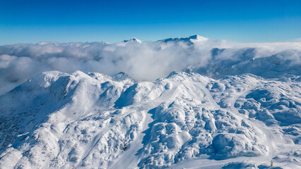 Aerial view of Vogel Ski Resort in Slovenia during winter with blanket of snow covers the slopes...