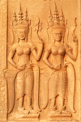 Two apsaras carved into a wall inside the temple of Angkor Wat, Siem Reap, Cambodia