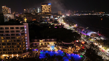 Obraz premium Aerial View of a Vibrant Night Market by the Beach.