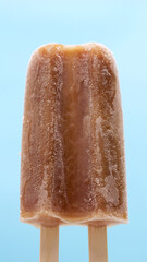  Frozen Brown Popsicle on Blue Background.