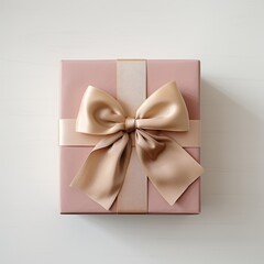 A beautifully wrapped pink gift box adorned with a satin bow, perfect for special occasions or celebrations.