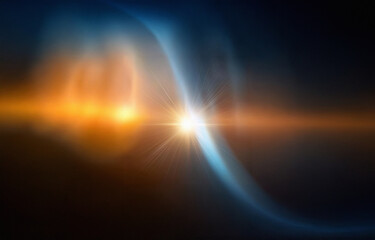 A bright, golden light bursts forth from a black background.