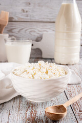 A bowl of fresh cottage cheese for breakfast on the table vertical view