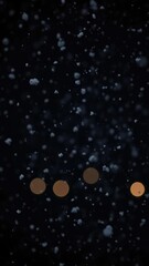 Obraz premium Softly falls snow at night with Bokeh lights on black background, cold, snowfall, atmospheric