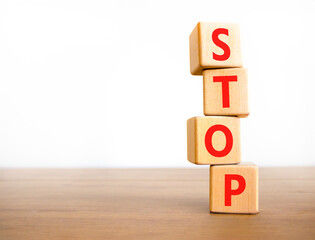 Stop symbol. Concept word Stop on beautiful wooden blocks. Beautiful wooden table white background....