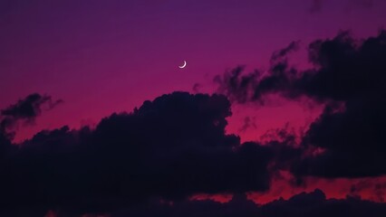 Fototapeta premium Dark purple misty clouds drift across a serene twilight sky with a subtle crescent moon, cloud formations, twilight