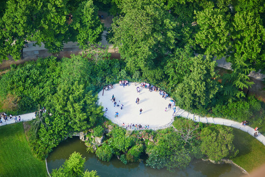 Aerial view of people sitting on the grass and having picnic on the Field of Mars, near the Eiffel tower in Paris, France