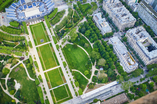 Aerial view of people sitting on the grass and having picnic on the Field of Mars, near the Eiffel tower in Paris, France