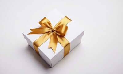 Obraz premium Elegant white gift box with a shiny gold ribbon, perfect for special occasions.